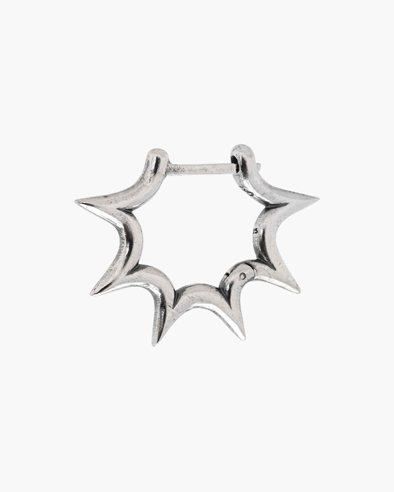 Silver burst huggie earring on a white background