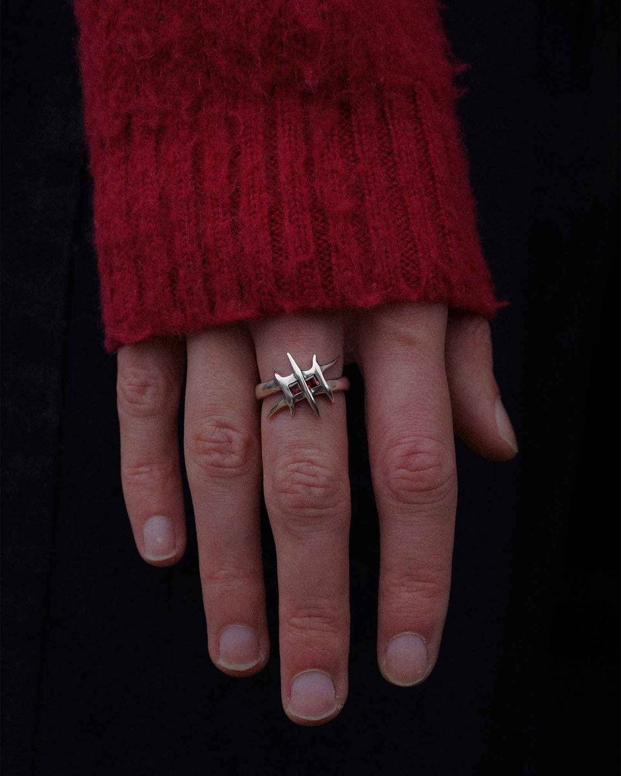 Close-up of a hand wearing the Bone Yards signet ring