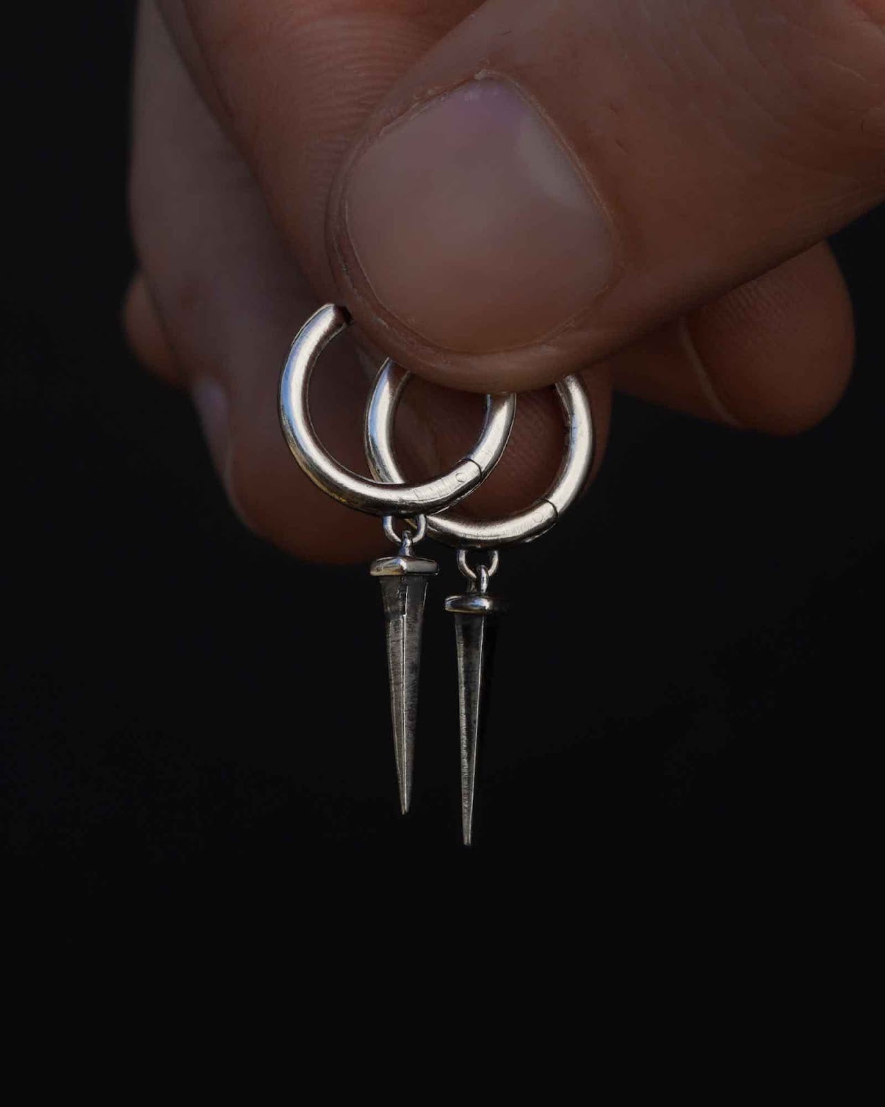 Close-up of a nail huggie earring detail