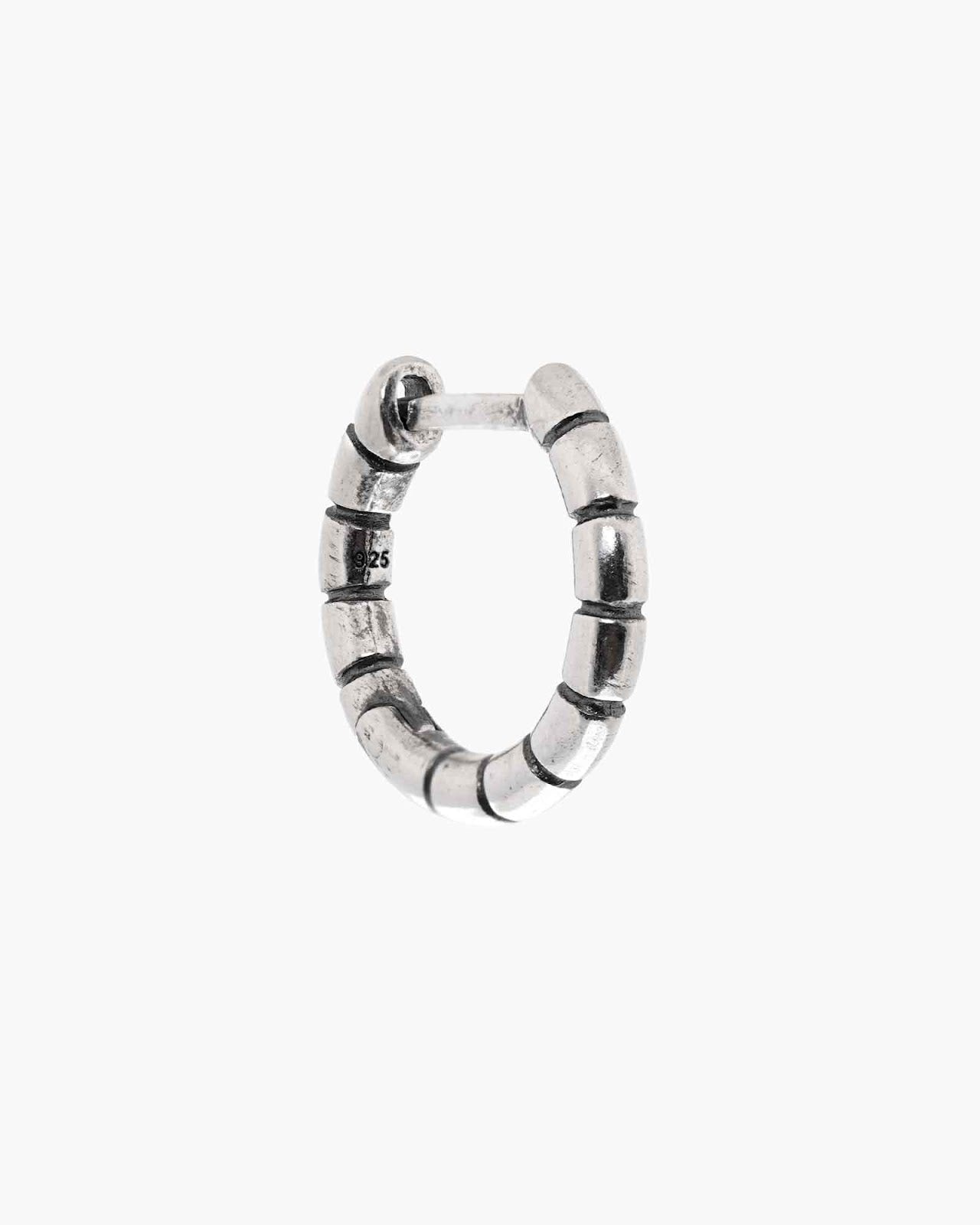 Silver Bandi Huggie earring on a white background