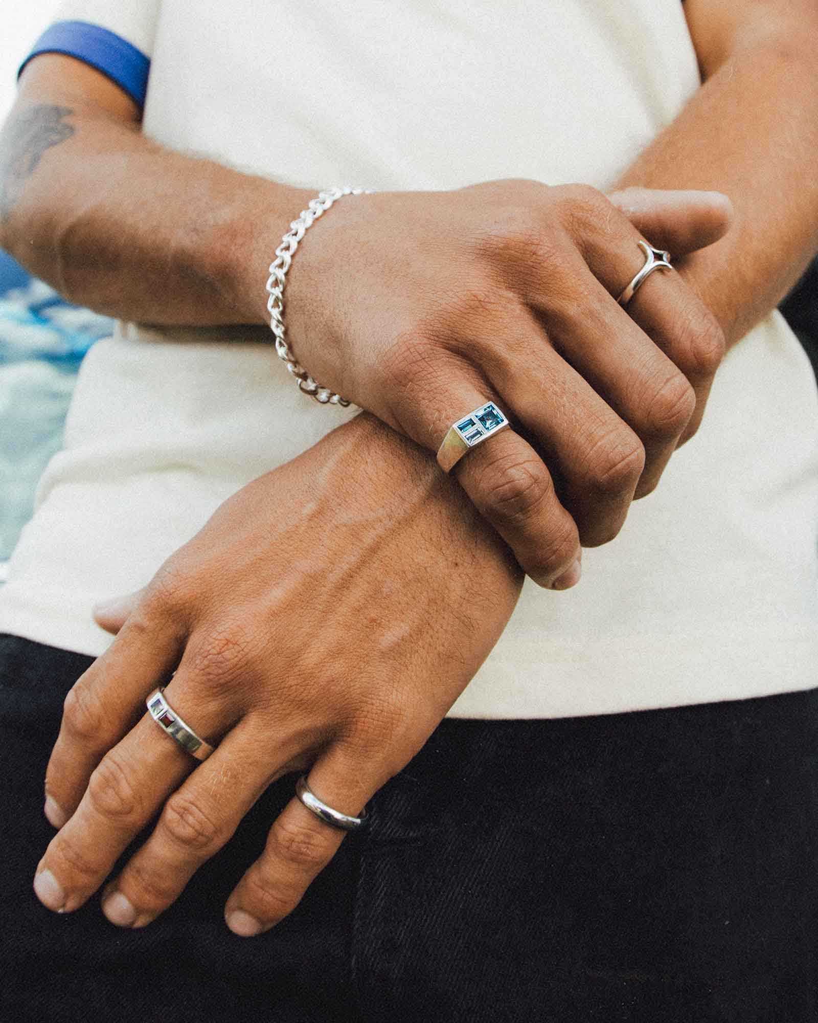 Close-up of hands with multiple rings and a bracelet