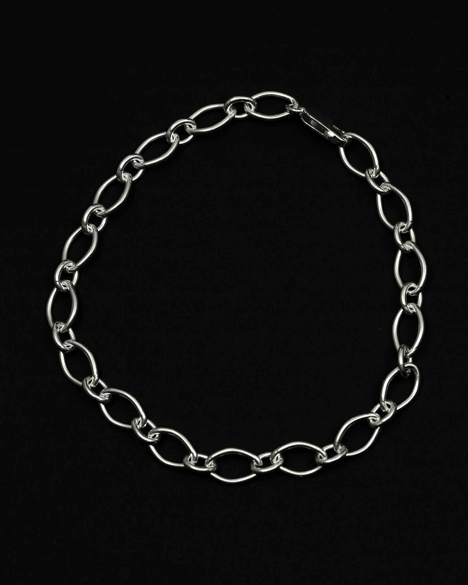 Silver chain bracelet on a black background