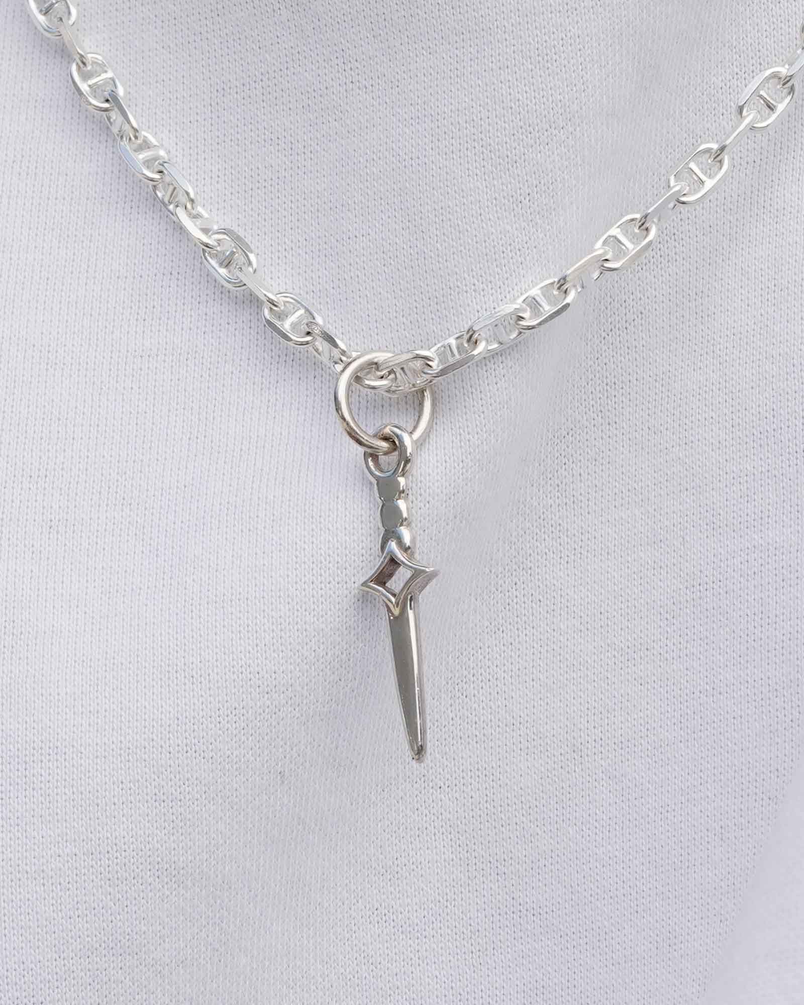 Silver necklace with a sword-shaped pendant on a light gray background