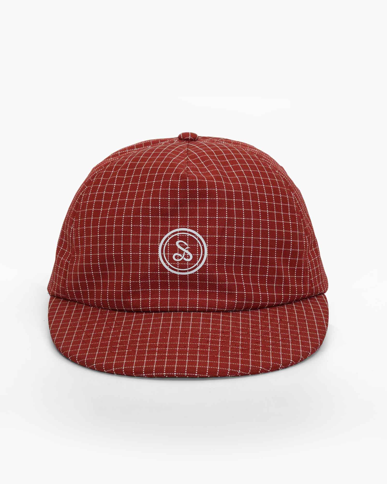 Red checkered cap featuring a white Sue The Boy logo on a plain white background