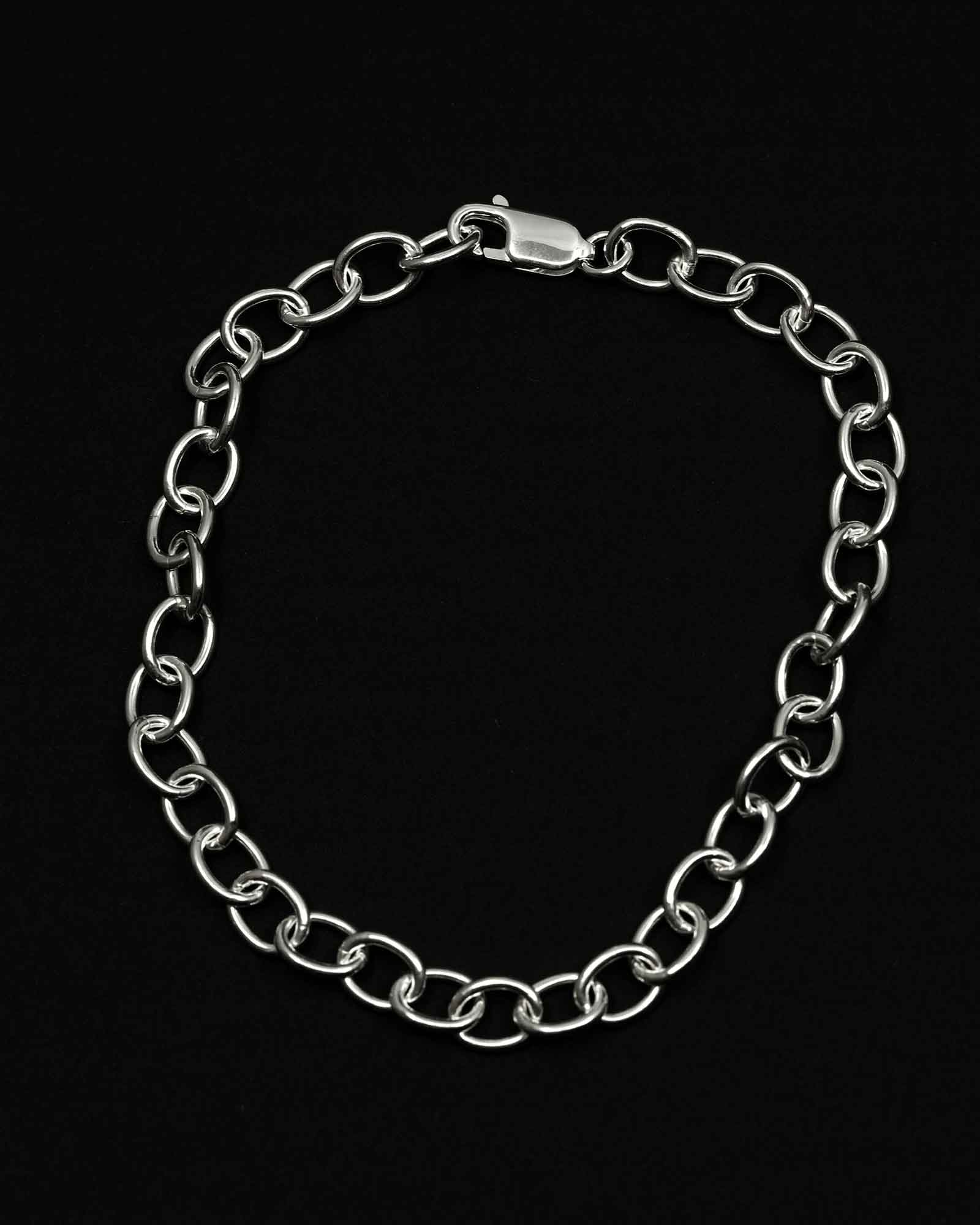 Silver chain bracelet on a black background