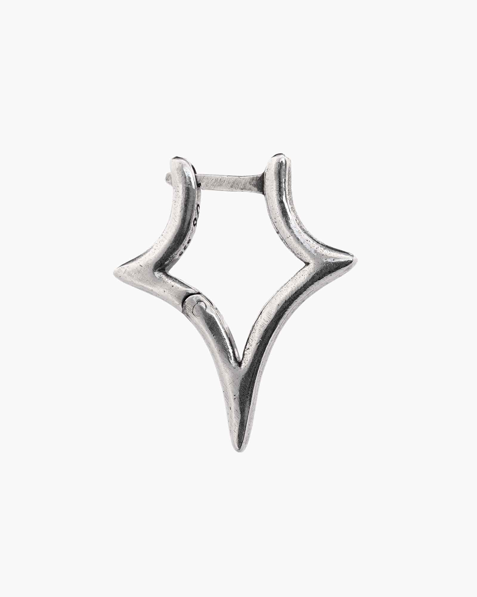 Star shaped silver earring on a white background