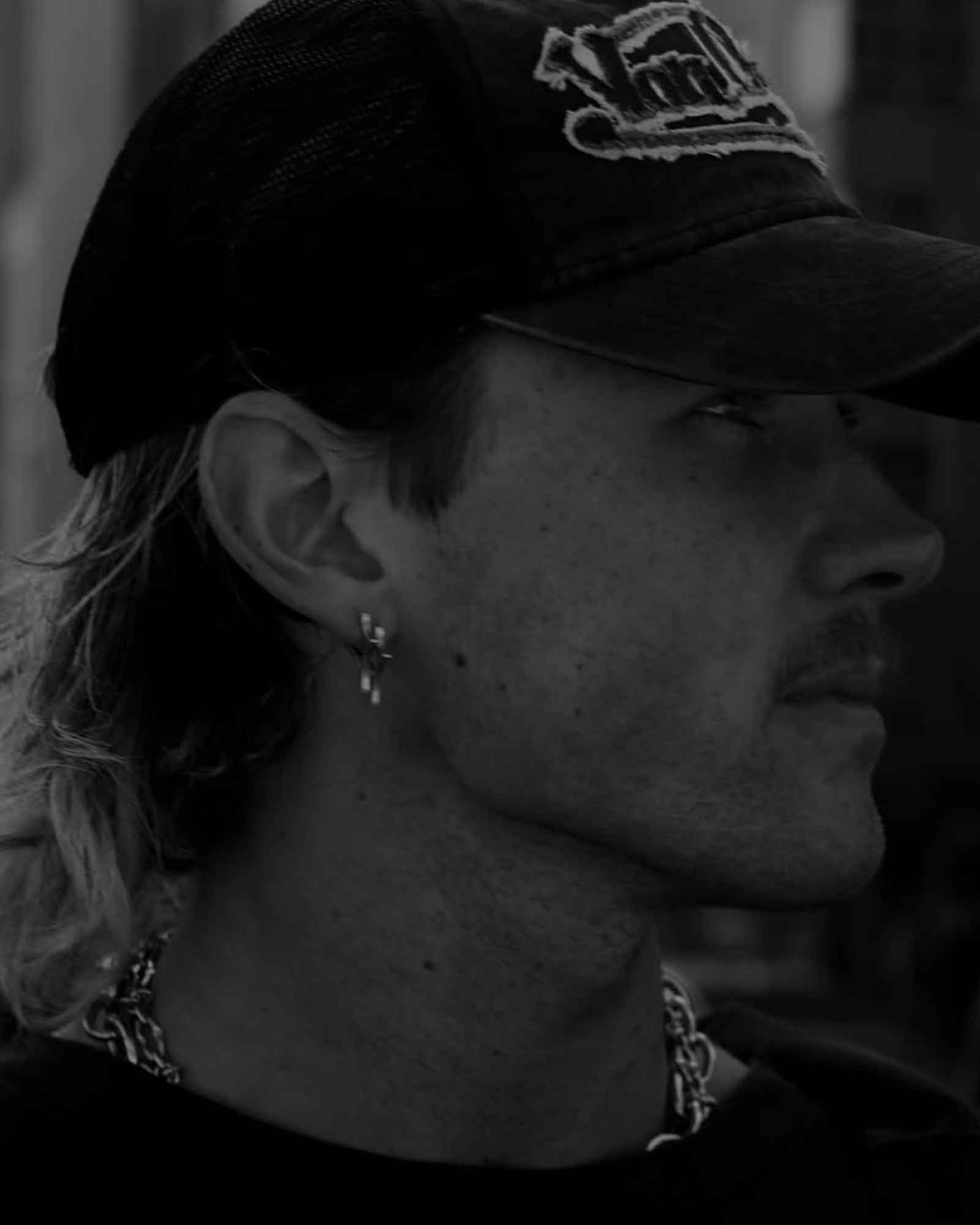 Black and white profile of a person wearing silver earrings