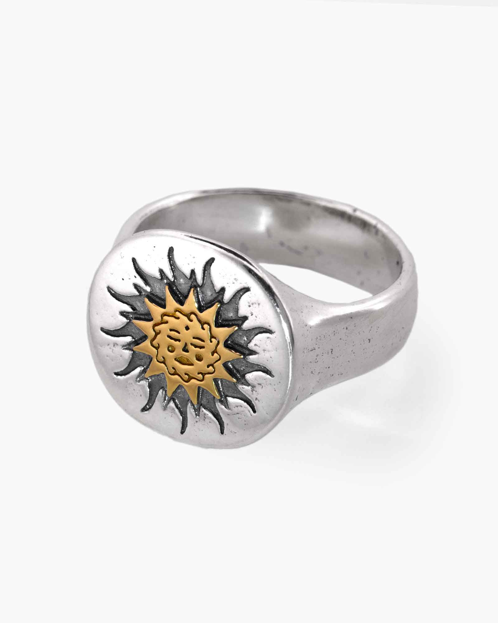 Silver ring with a sun design on a white background