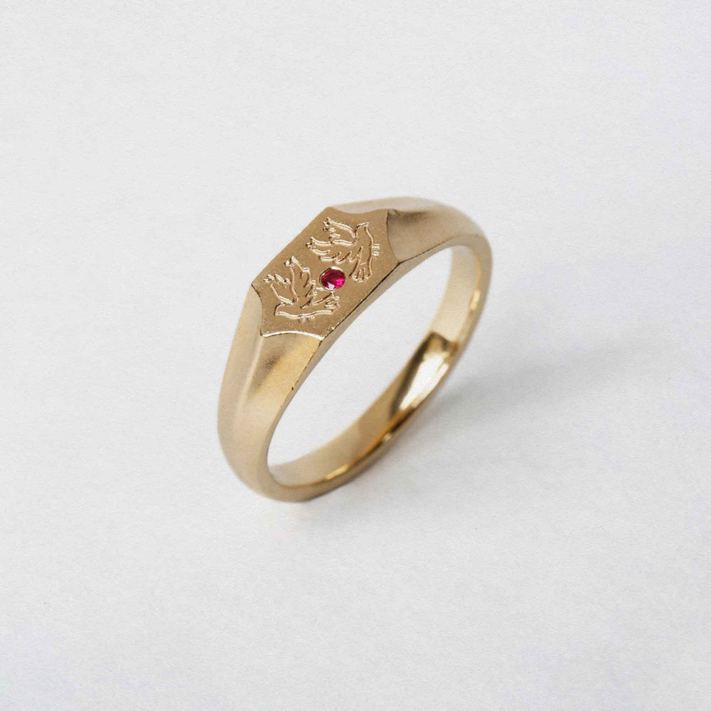 Two birds and a ruby stone on a 9CT gold signet ring