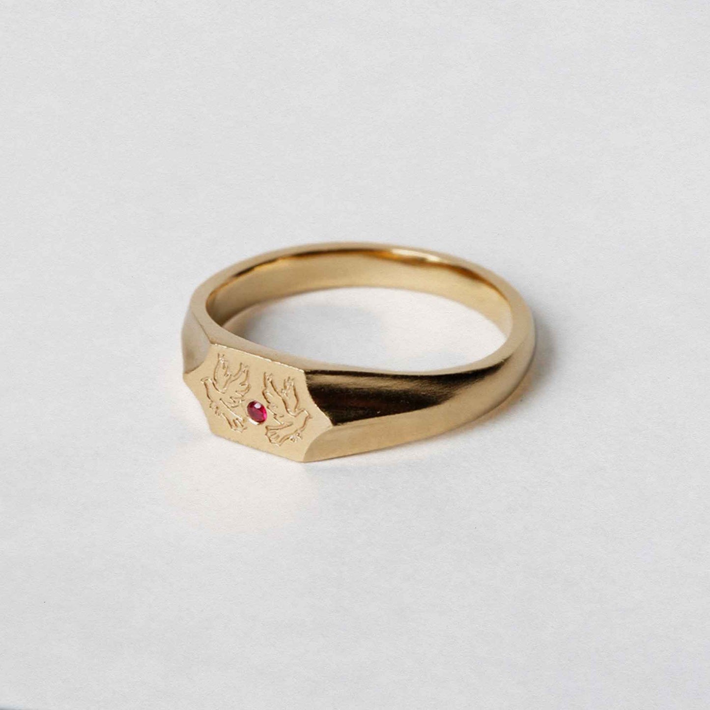 Two birds and a ruby stone on a 9CT gold signet ring