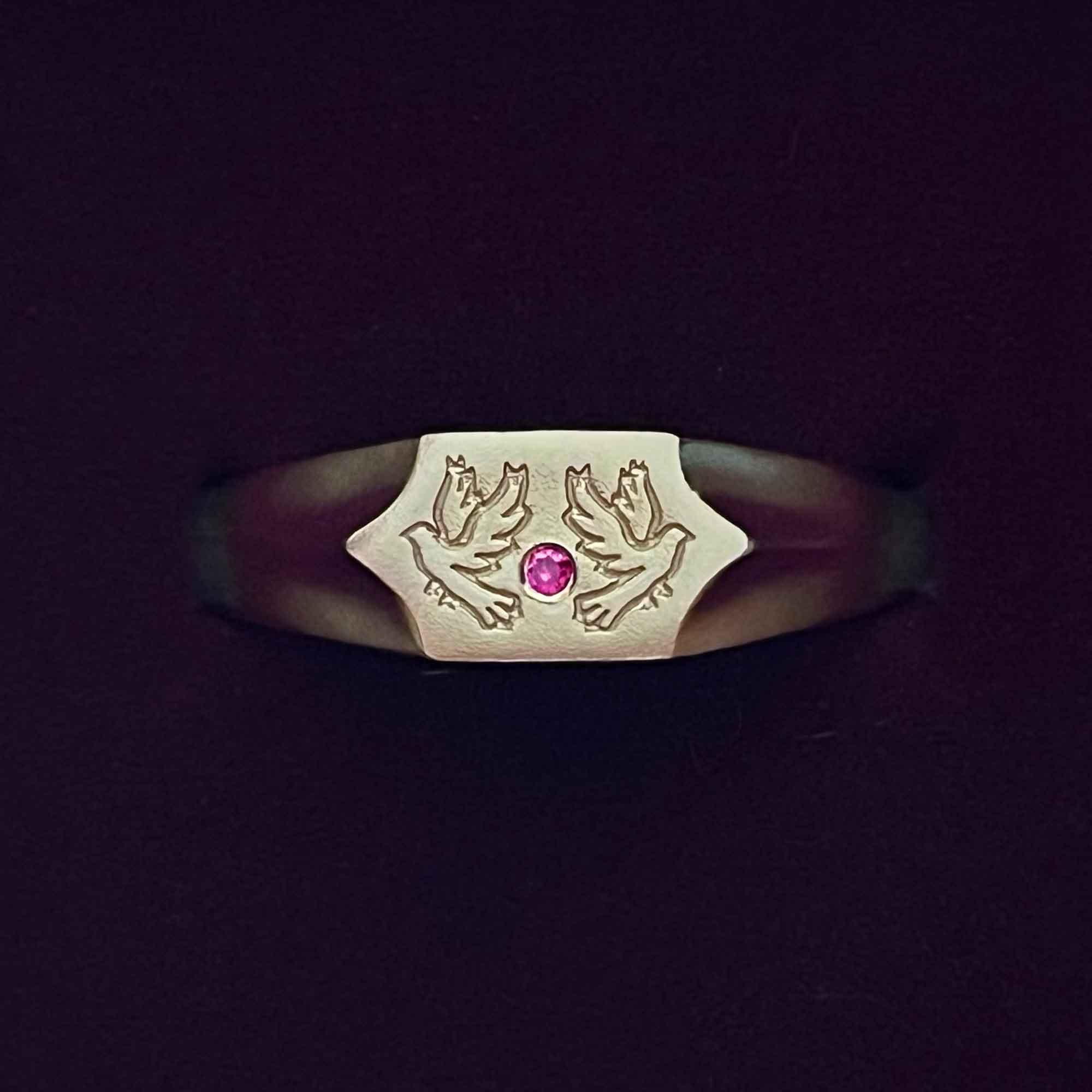 Two birds and a ruby stone on a 9CT gold signet ring