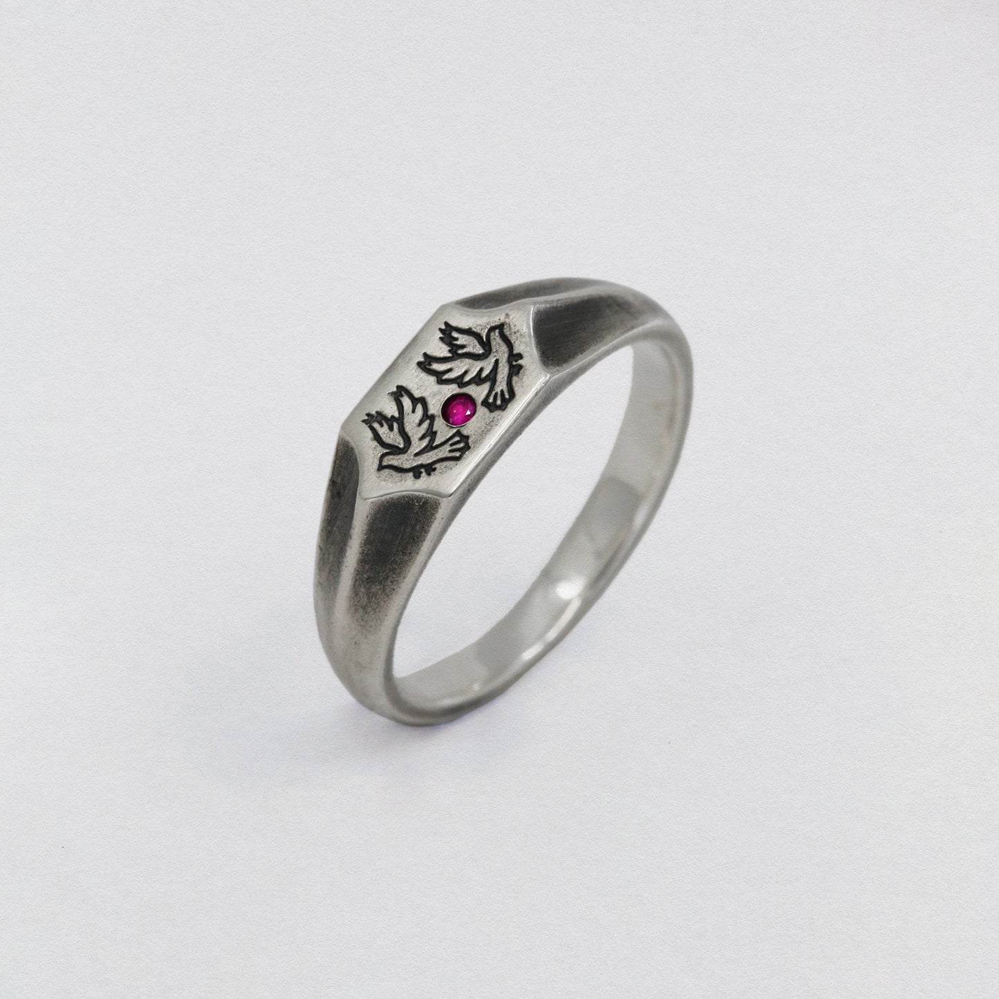 Two birds and a ruby stone on a 925 silver signet ring