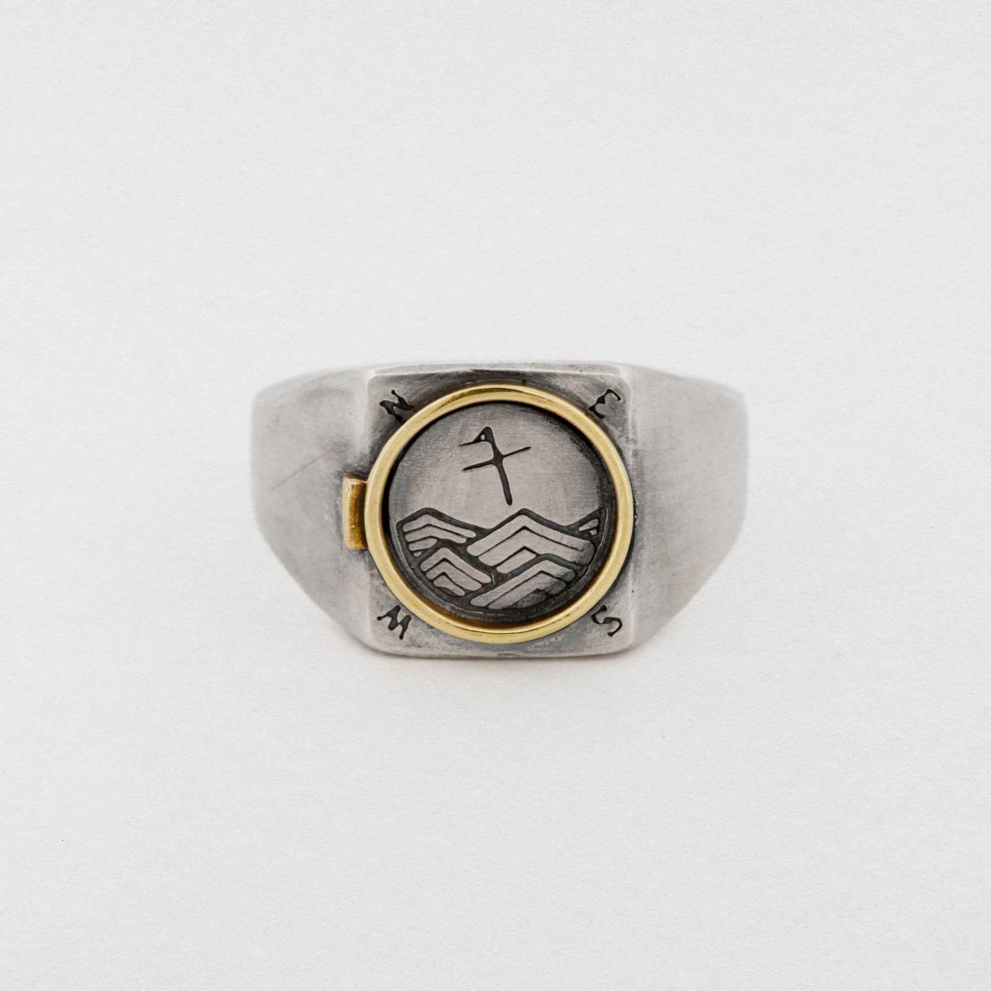 A Silver Signet Ring With Brass Porthole Inlay
