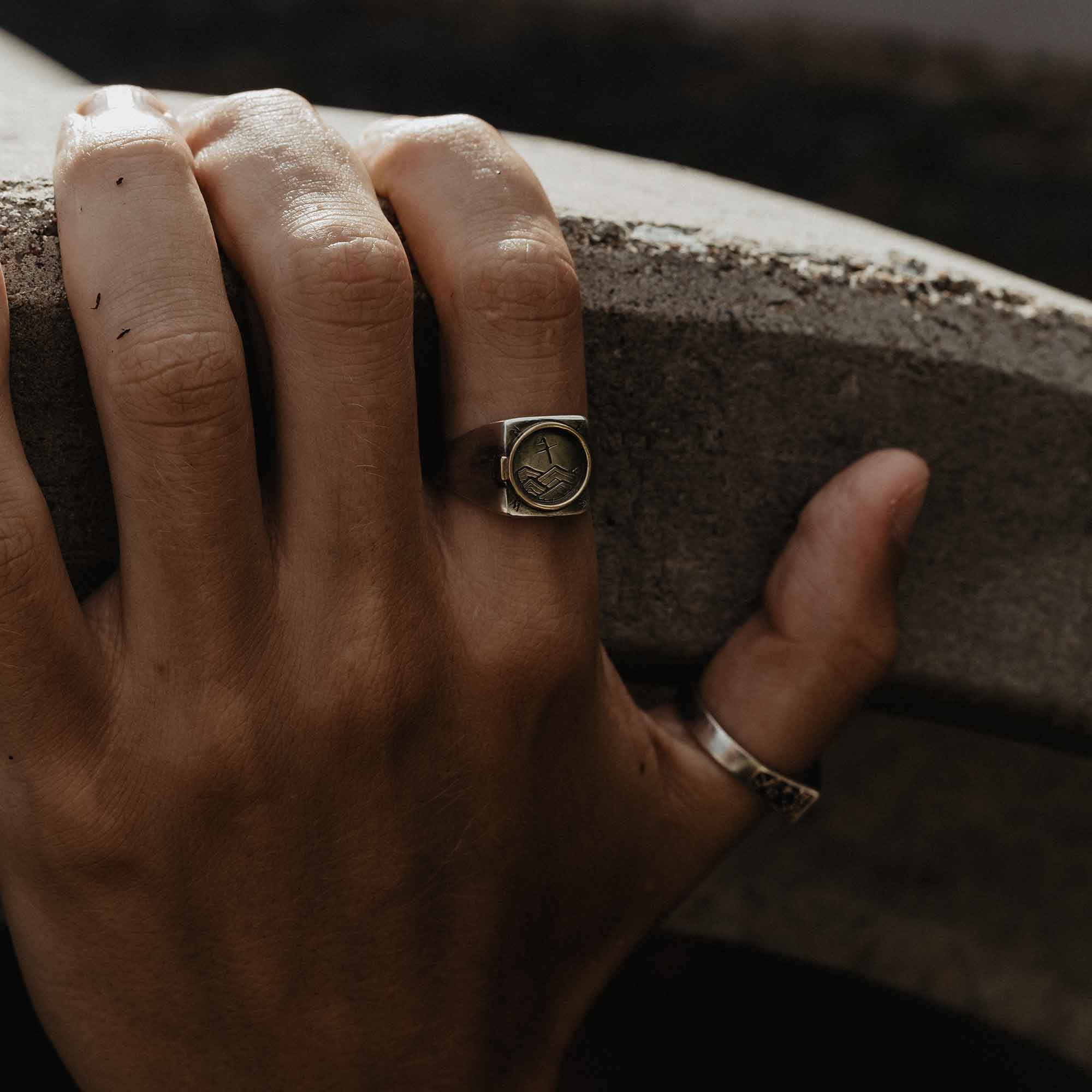 A Silver Signet Ring With Brass Porthole Inlay