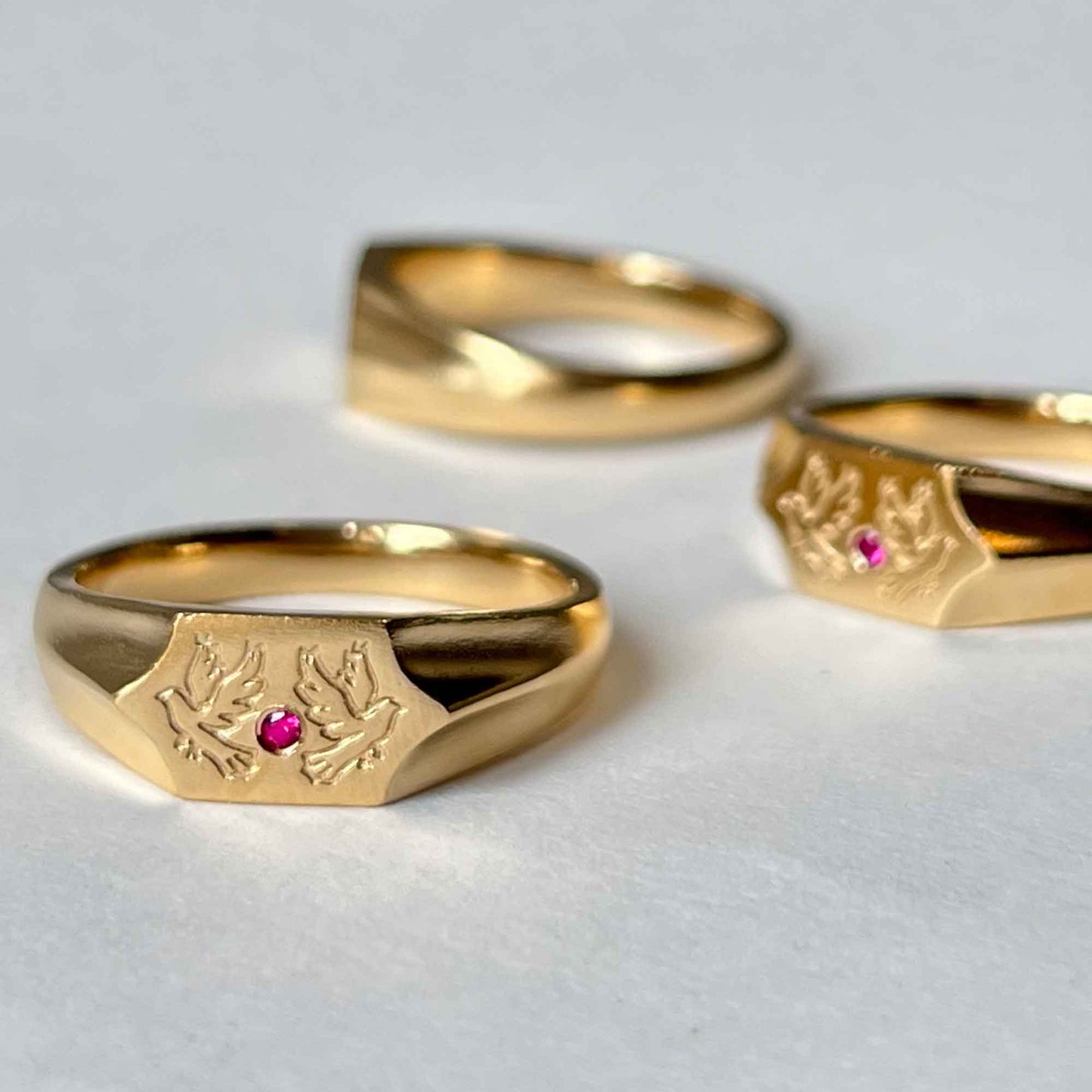 Two birds and a ruby stone on a 22CT gold vermeil signet ring