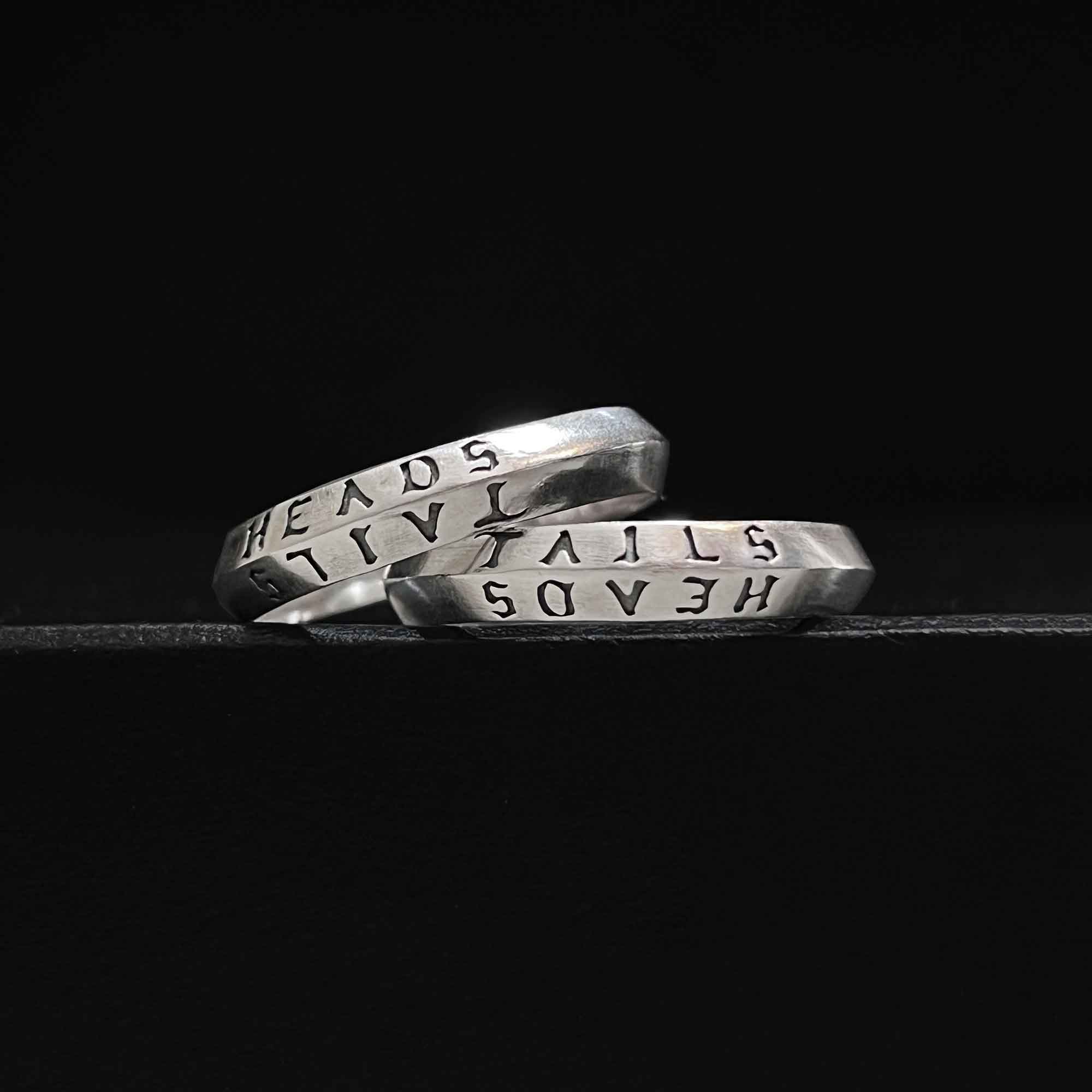 heads + tails engraved on a 925 silver band ring