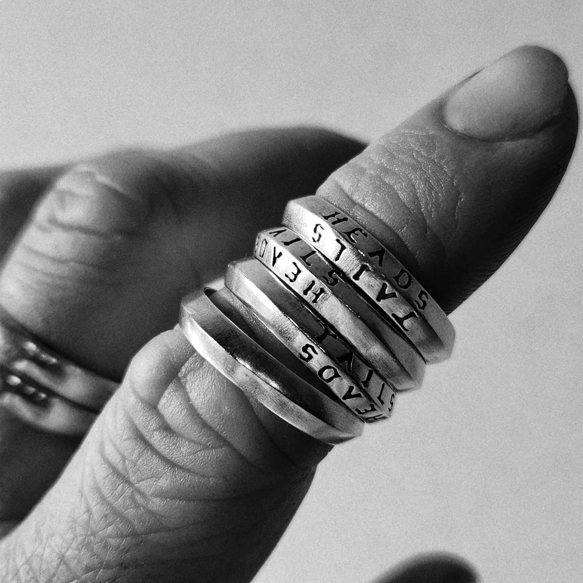 heads + tails engraved on a 925 silver band ring