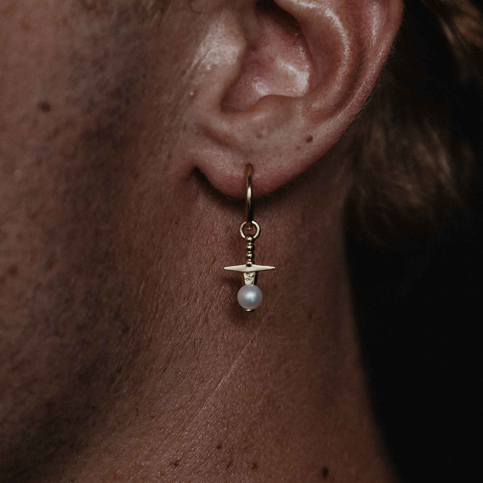 9CT gold sword earring though pearl stone